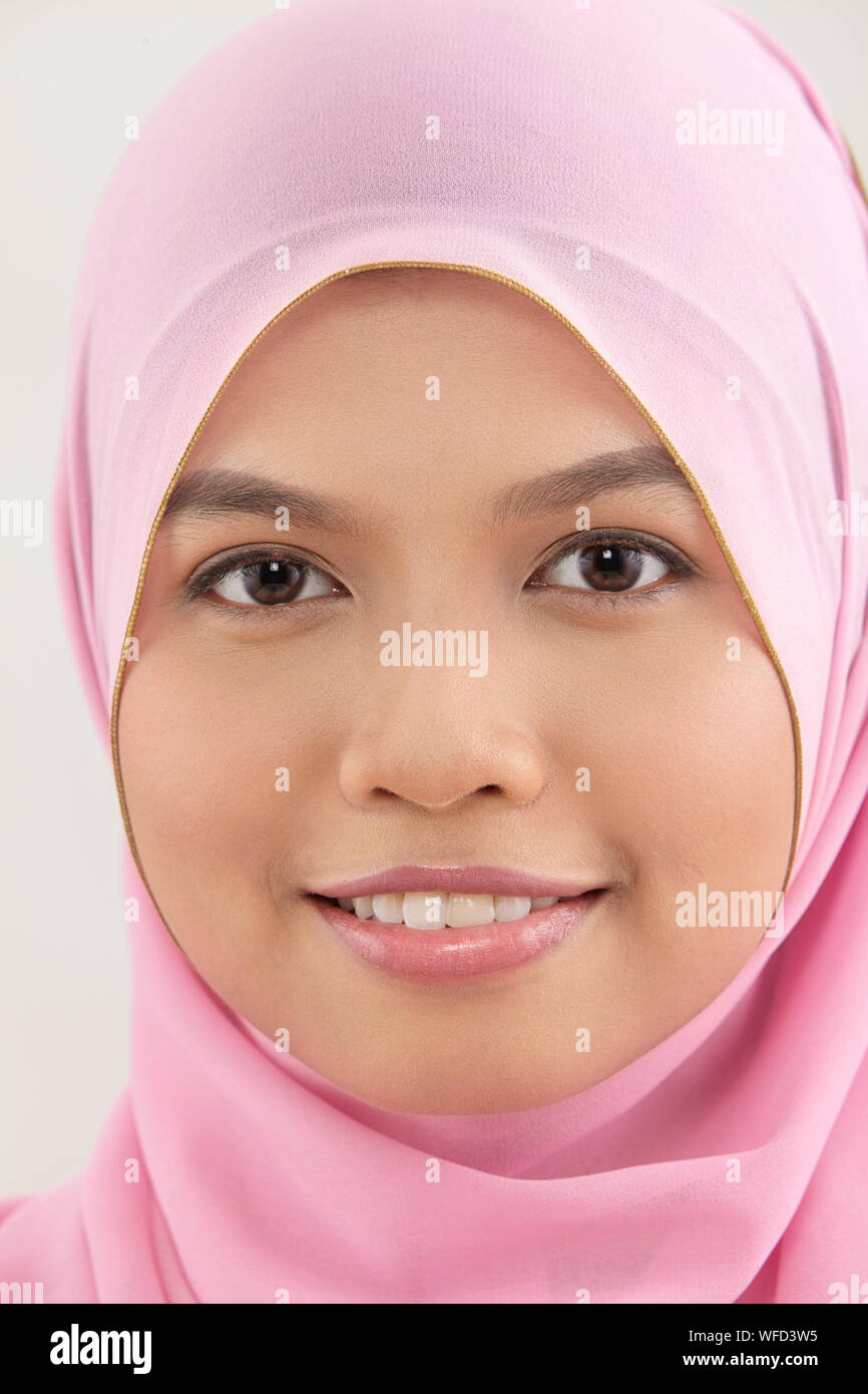 close up of malay woman with tudung looking at camera Stock Photo