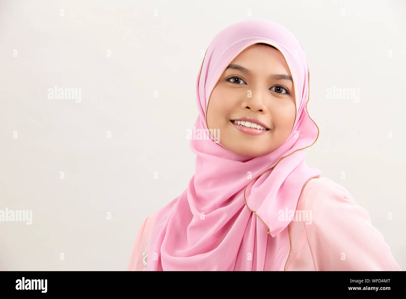 Happy malay woman with tudung looking at camera Stock Photo