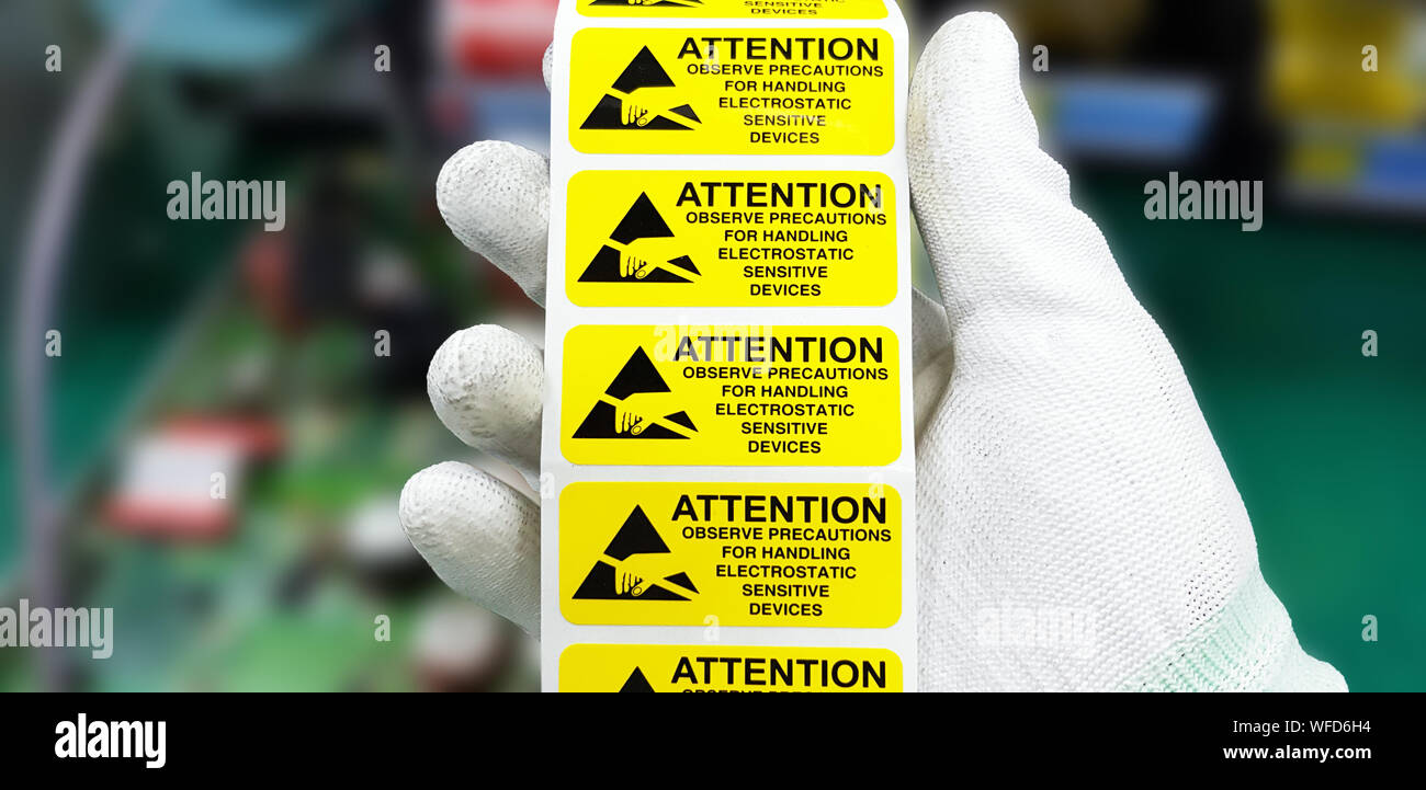 Hand holding ESD symbol label with antistatic gloves,Electrostatic
