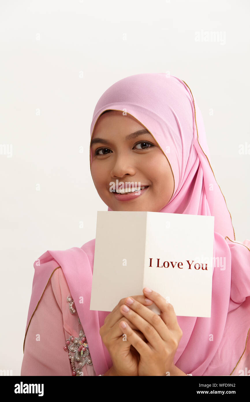malay woman with tudung holding i love you greeting card Stock Photo