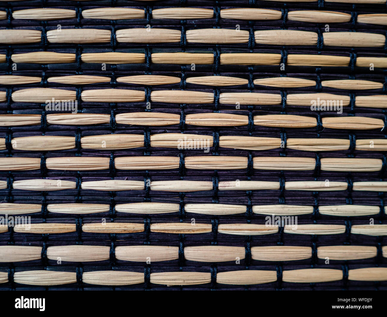Bamboo woven with black fabric, textured surface Stock Photo