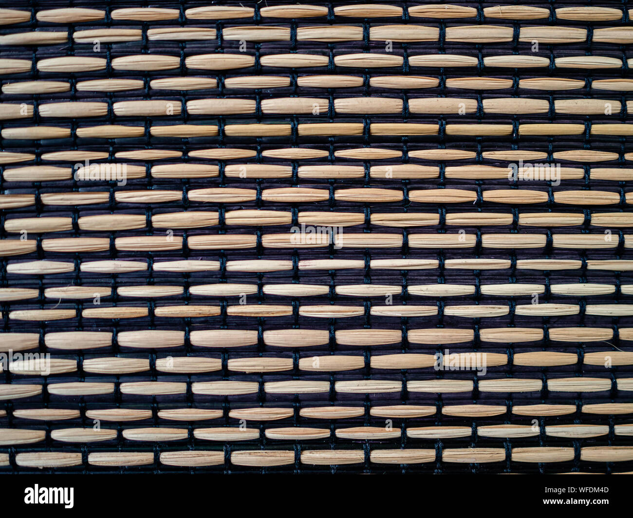 Bamboo woven with black fabric, textured surface Stock Photo