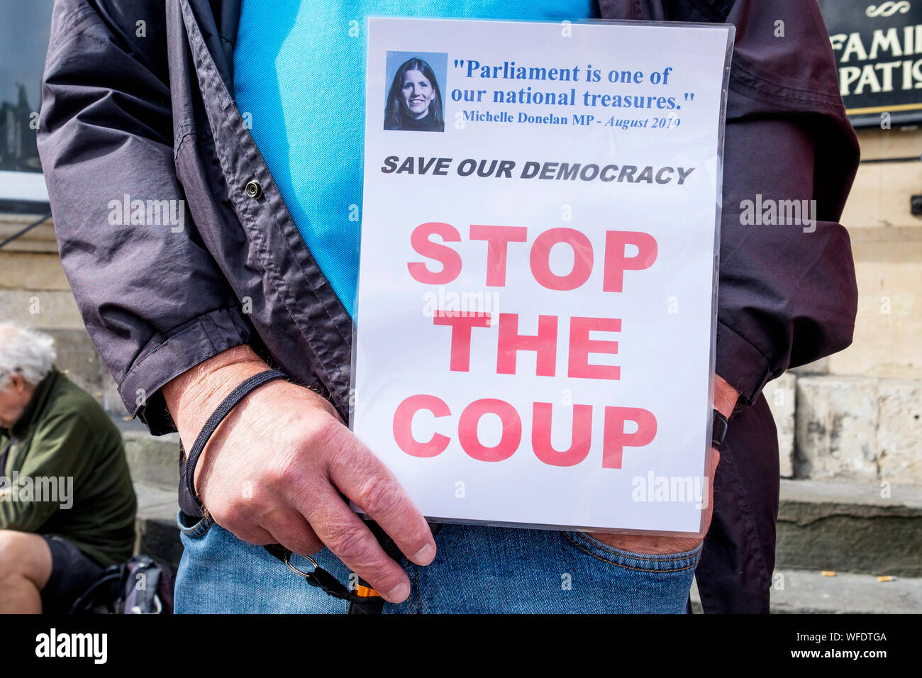 Chippenham, Wiltshire, UK. 31 August, 2019. A protester holding a 'stop the coup' sign is pictured as he protests outside the Chippenham offices of Michelle Donelan, the Conservative MP for Chippenham. The protest against Boris Johnson's decision to prorogue Parliament was organised by the Chippenham constituency Labour Party. Credit: Lynchpics/Alamy Live News Stock Photo