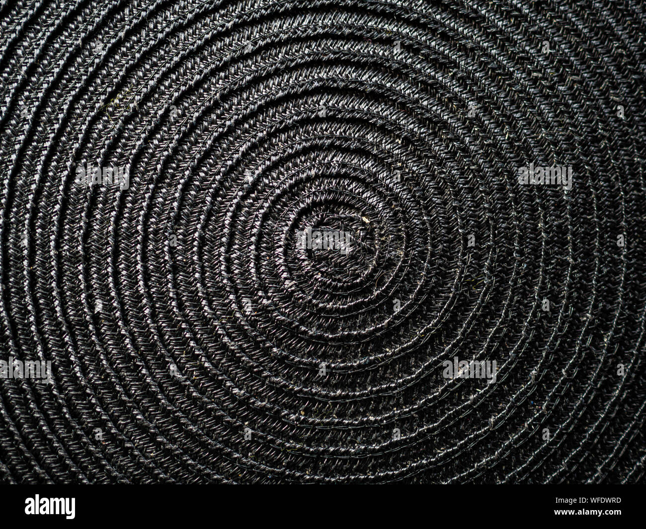 Black abstract woven surface with spiral circles Stock Photo