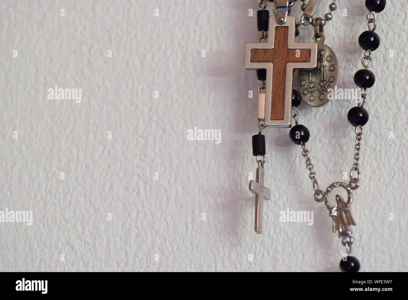 Close-up Of Rosaries Hanging On Wall Stock Photo