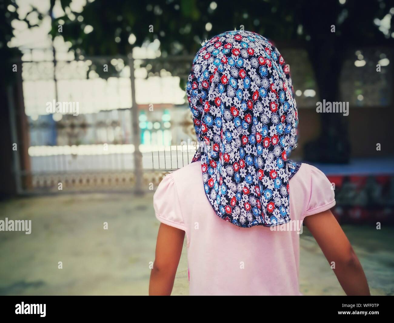 Rear View Of Girl Wearing Floral Headscarf Stock Photo
