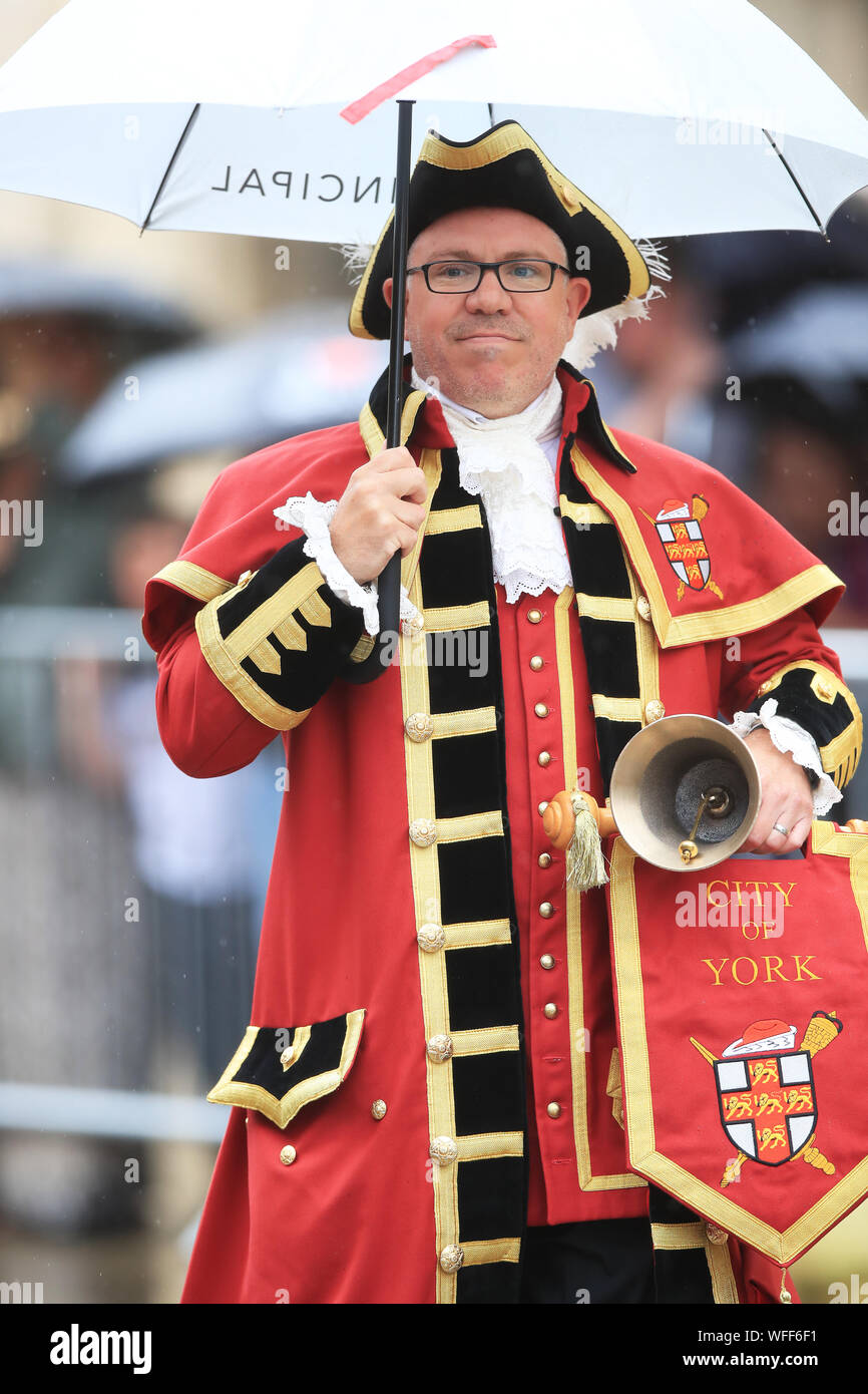 York's town crier Ben Fry stands in the rain outside York Minster ahead