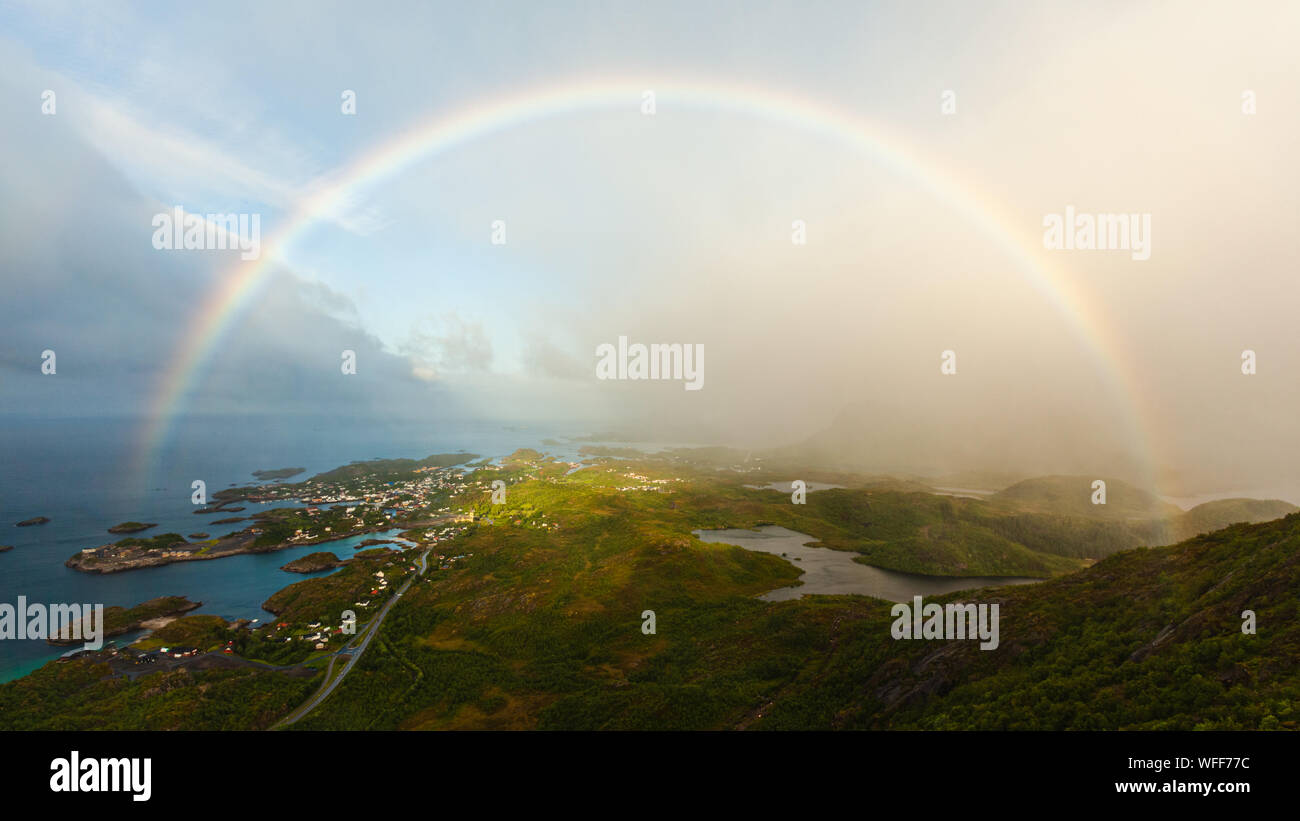 A rainbow over Kabelvåg, Lofoten, from the peak of Tjeldbergtind during a storm Stock Photo