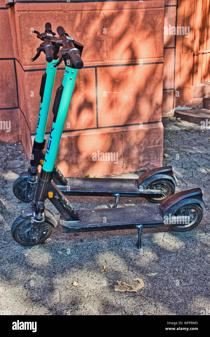 Mainz, Germany - August 31, 2019: Two parked rental scooters in the city of Mainz. Stock Photo