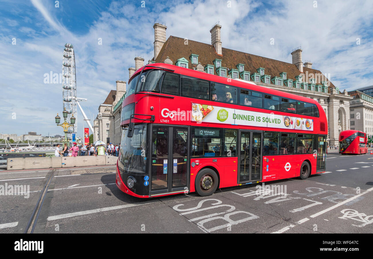 Wrightbus New Routemaster bus, also known as New Bus for London, a hybrid red London bus in Westminster, City of London, UK. Bus London transport. Stock Photo