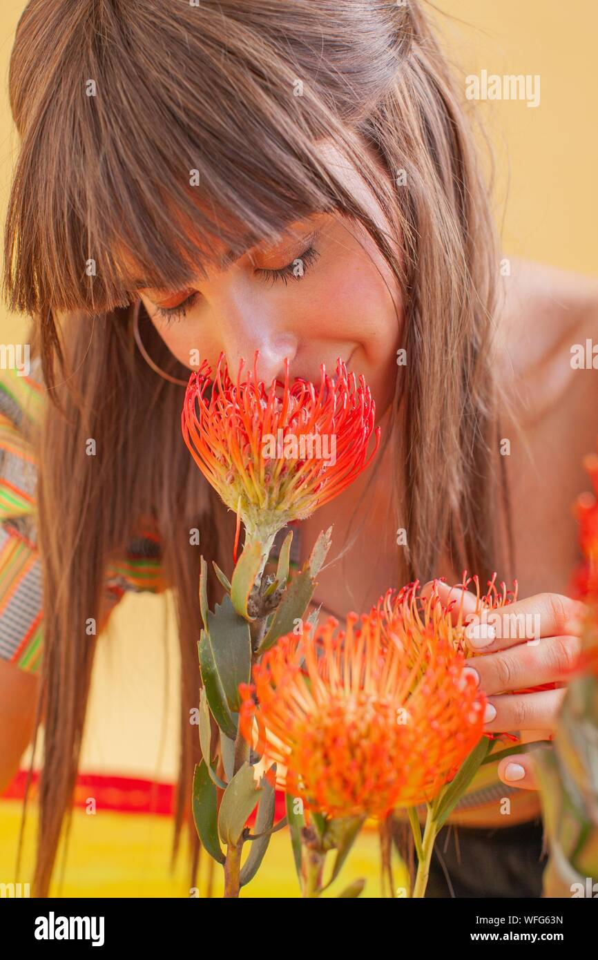 Portrait of a Woman smelling flowers Stock Photo