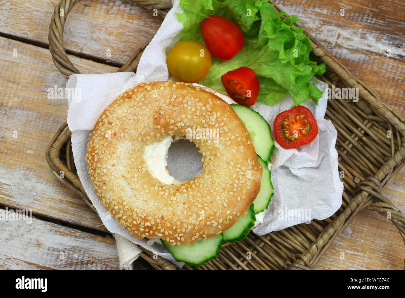 Sesame seed white bagel with cream cheese and cucumber Stock Photo