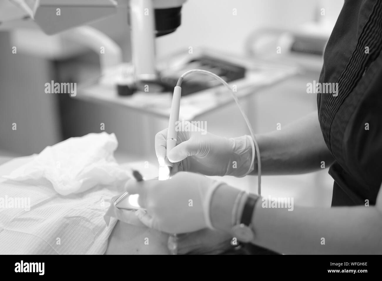The dentist performs manipulations to treat the patient's teeth in the clinic Stock Photo