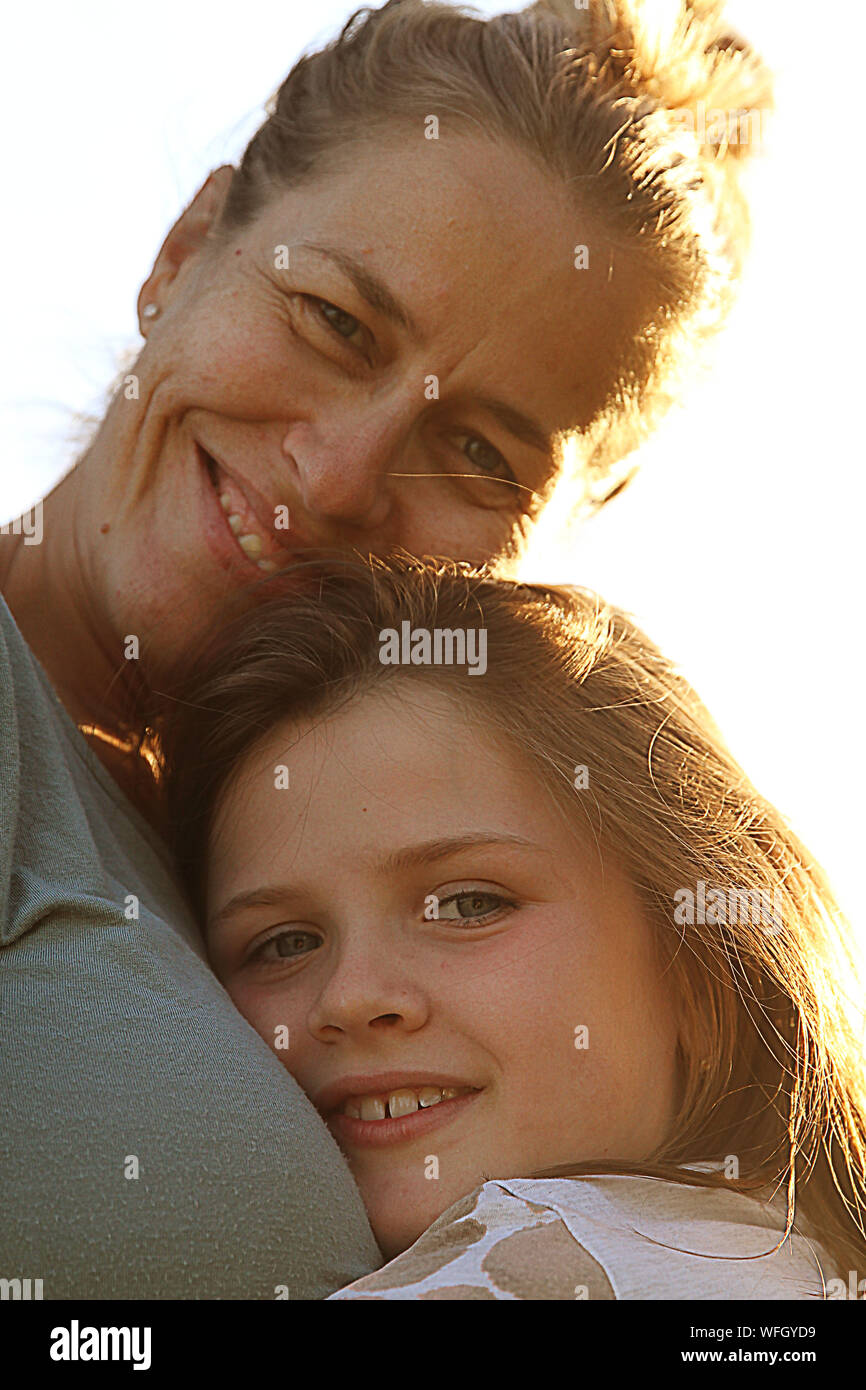 Portrait of a smiling mother and daughter hugging Stock Photo