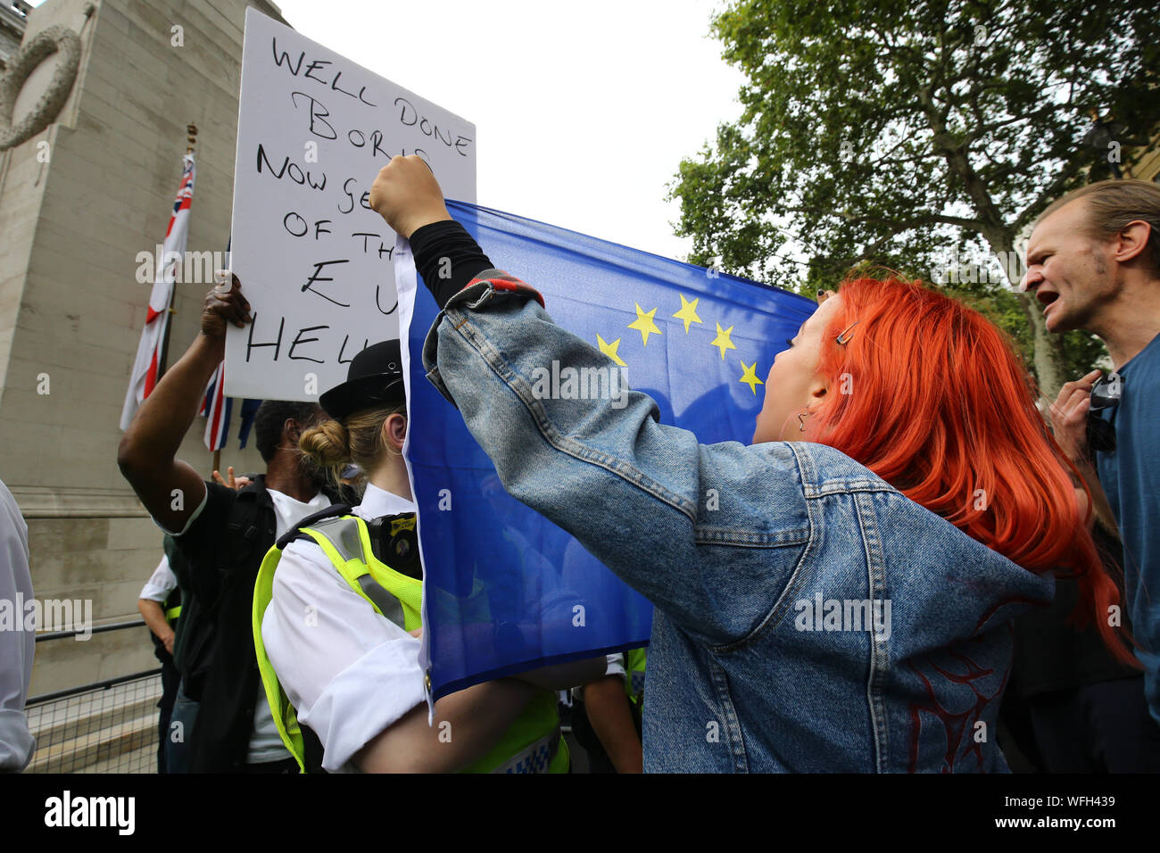 A Protester Taking Part In The Let Us Vote Day Of Action Organised By Another Europe Is Possible Campaign Group Holds A European Flag Up To A Police Officer And A Pro Brexit A Protester Taking Part In The Let Us Vote Day Of Action Organised By Another Europe Is Possible Campaign Group Holds A European Flag Up To A Police Officer And A Pro Brexit