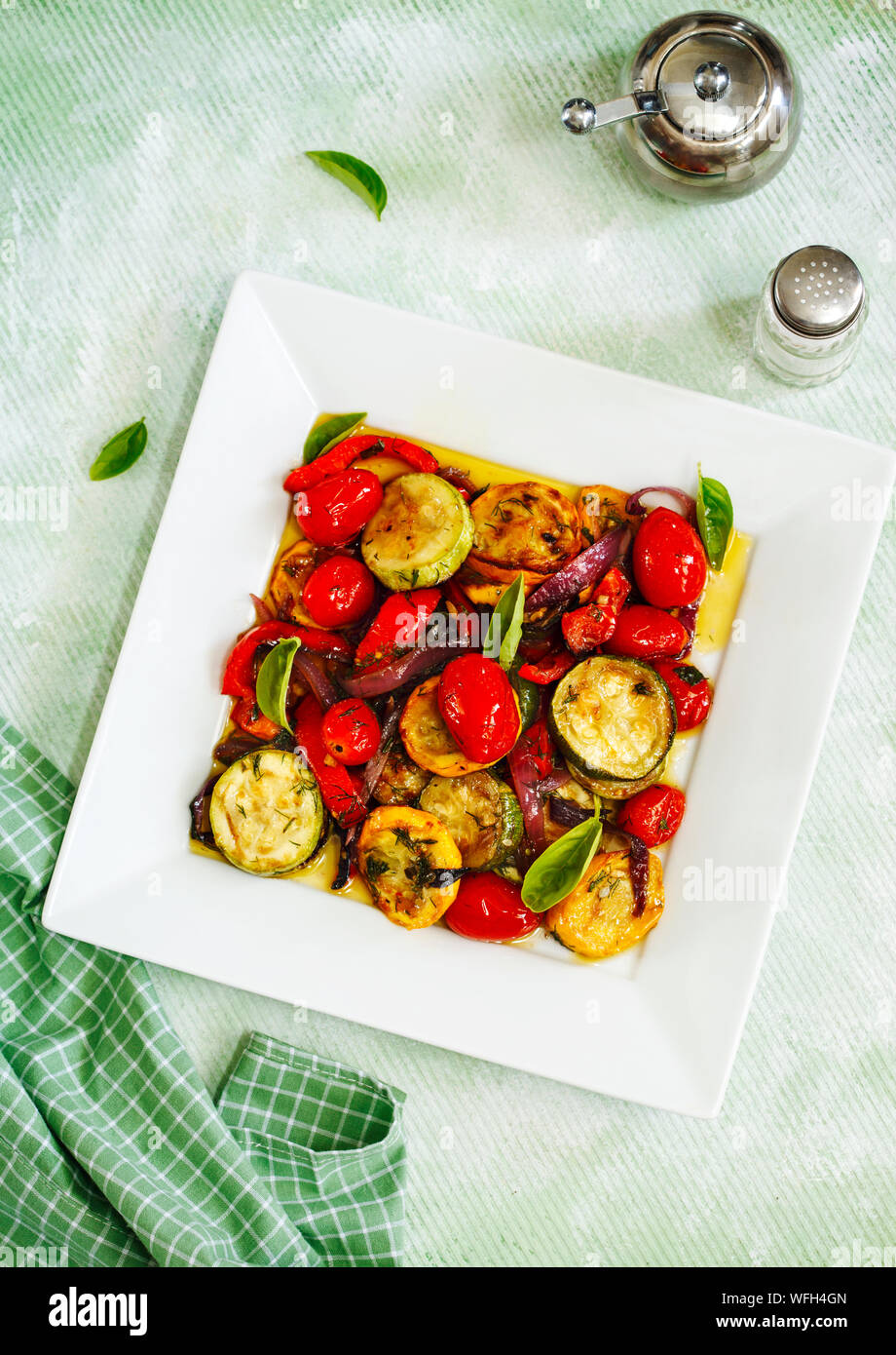 Grilled vegetable salad with peppers, courgettes, onions and tomatoes Stock Photo
