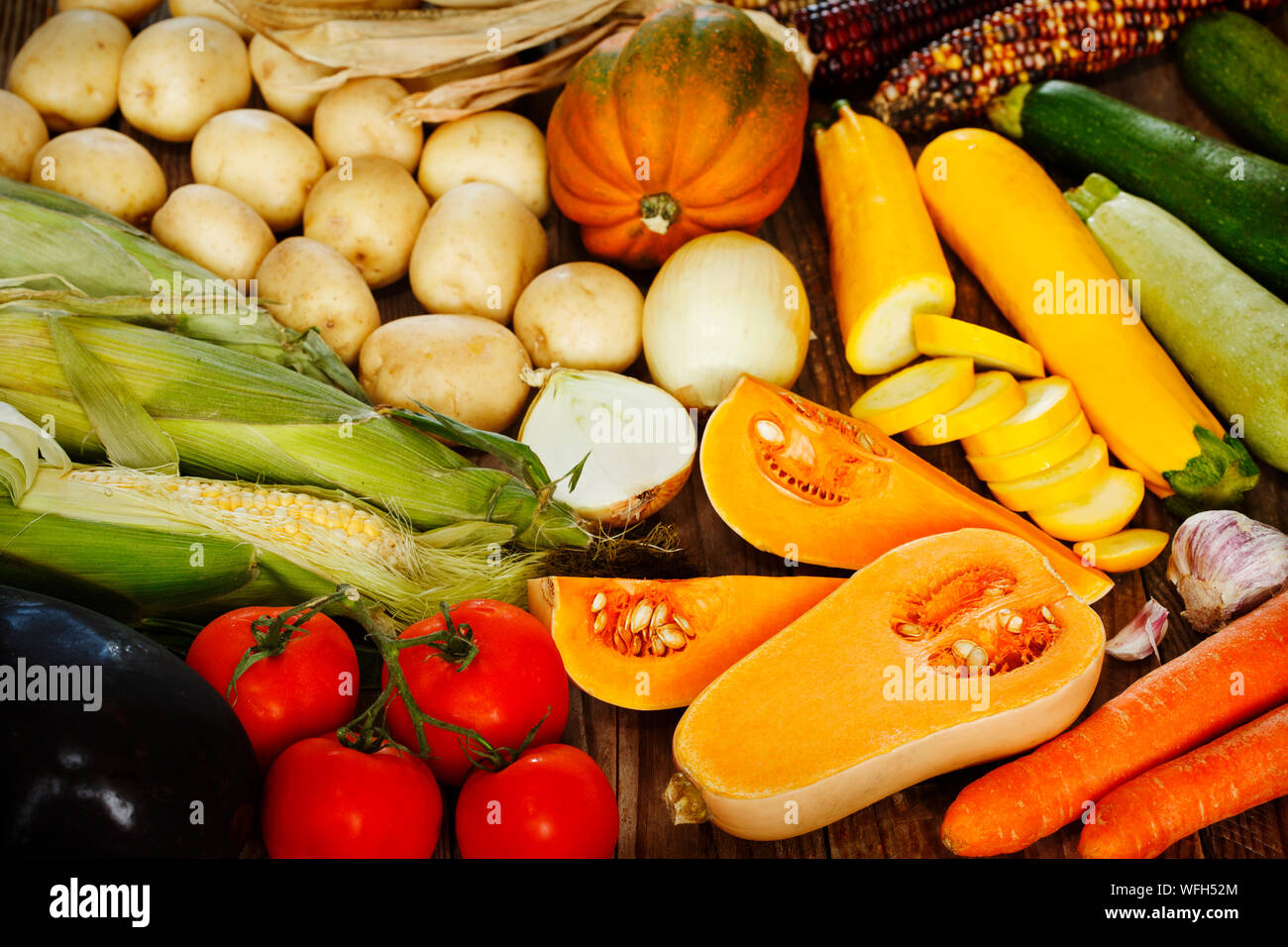 Arrangement of various fruit and vegetables on a wooden table Stock Photo