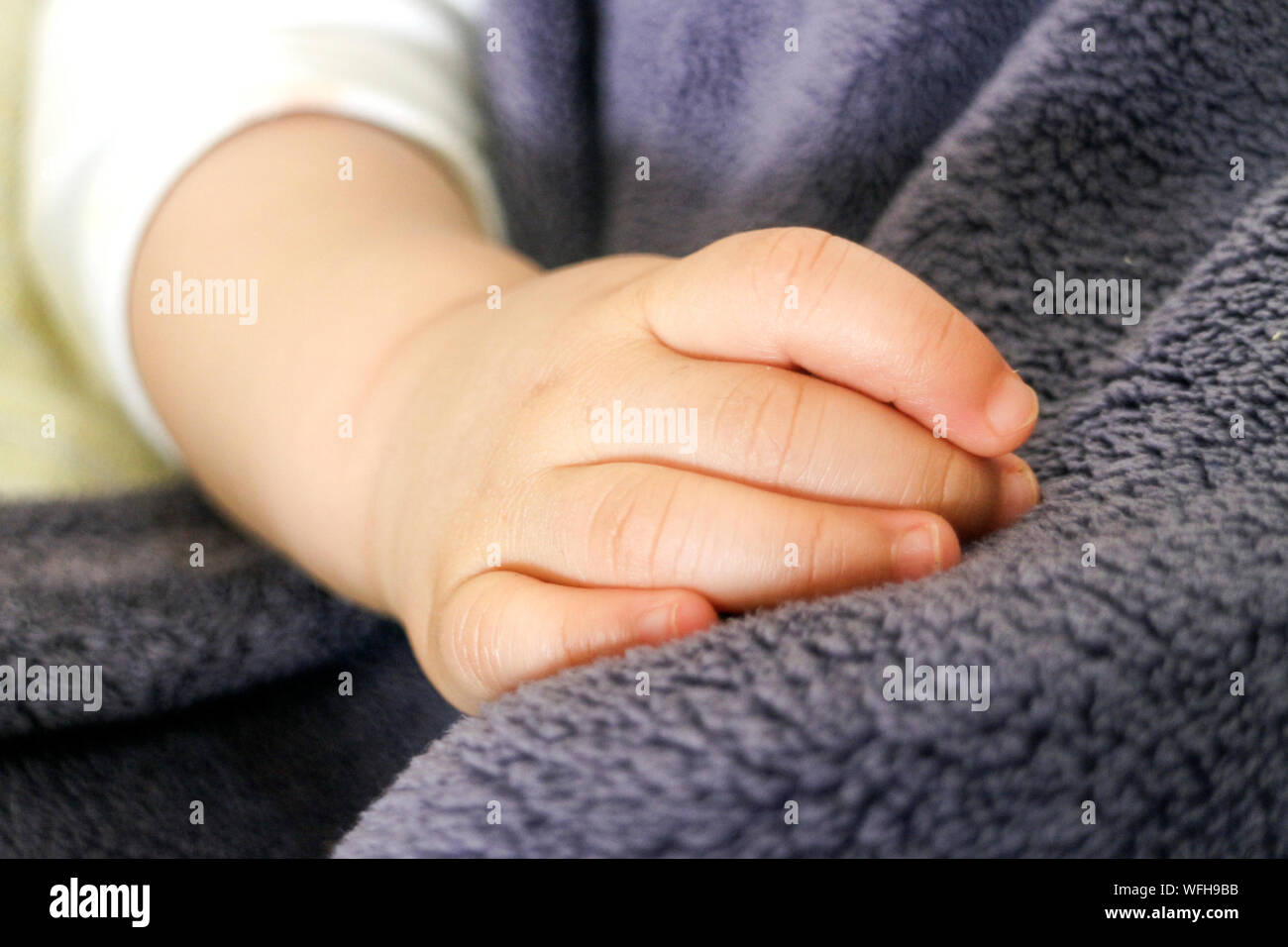 Cropped Hand Of Baby On Towel Stock Photo