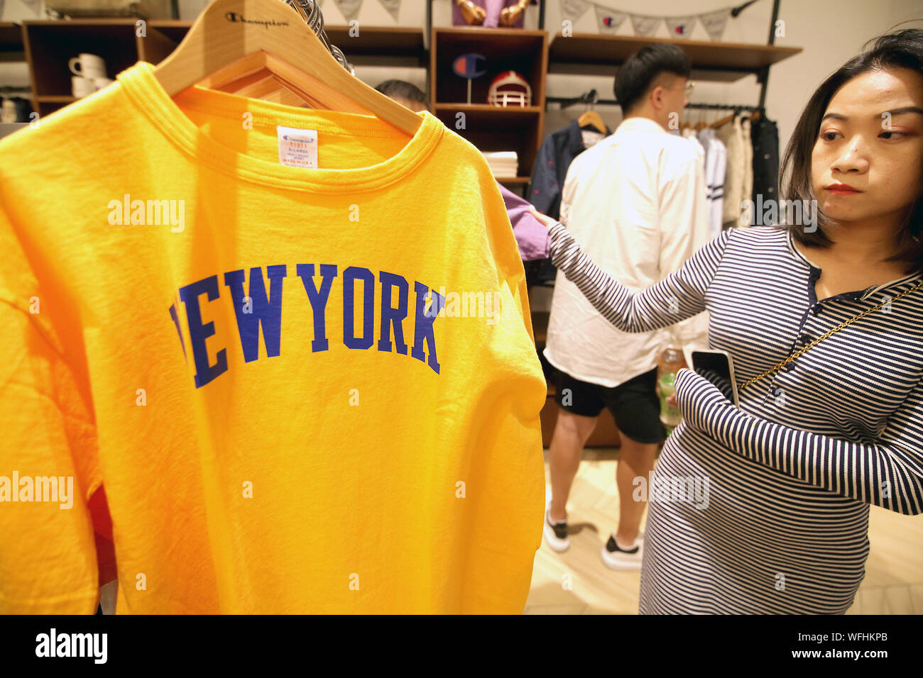 Chinese shop at a Champion apparel store in an international shopping mall in Beijing on Saturday, 31 August 2019.  U.S. President Donald Trump's latest tariffs targets Chinese-made products exported to the U.S., including U.S. clothing, shoes and appliances.    Photo by Stephen Shaver/UPI Stock Photo
