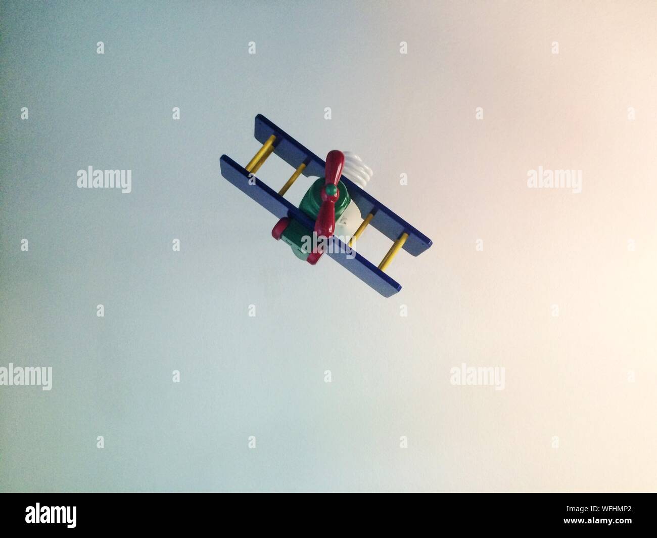 Low Angle View Of Toy Plane Flying Against Clear Sky Stock Photo