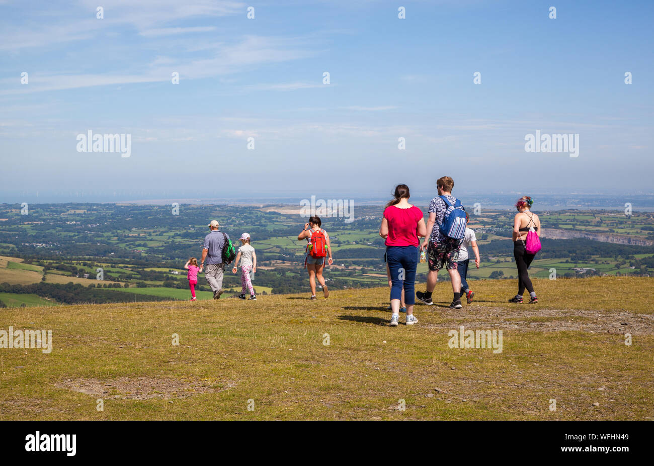 Men women children and families in the Clwydian Hills North Wales on the summit of Moel Famau  mountain Stock Photo