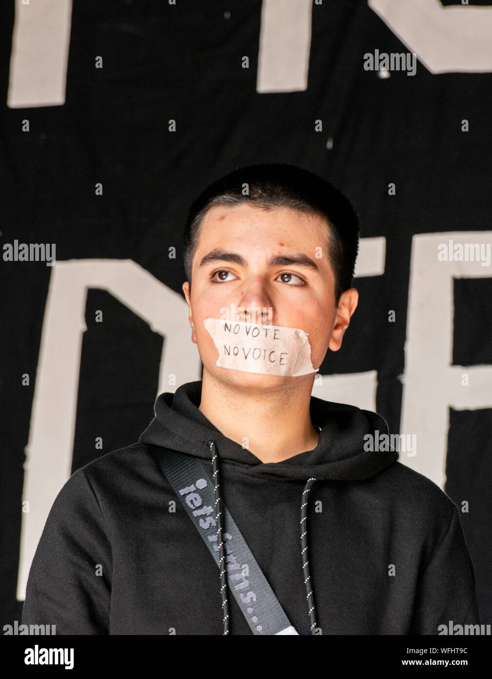 Young protester with tape on his mouth saying No Vote No Voice at ‘Stop the Coup, Defend Democracy’ protest outside Downing Street, Central London, UK, 31 August 2019 Stock Photo