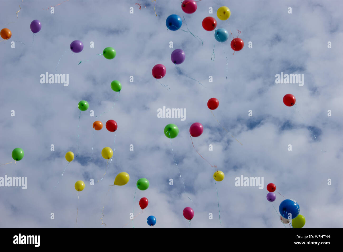 Multi-colored balloons in the sky with clouds Stock Photo - Alamy