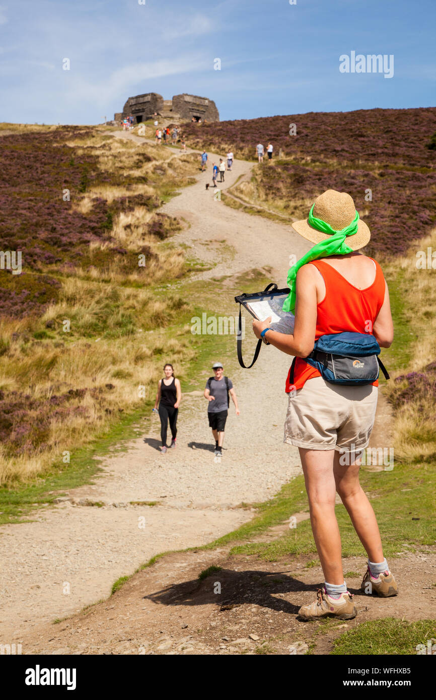 Men women children and families walking Offas Dyke footpath in the Clwydian Hills near the Jubliee Tower on the summit of Moel Famau  mountain Wales Stock Photo