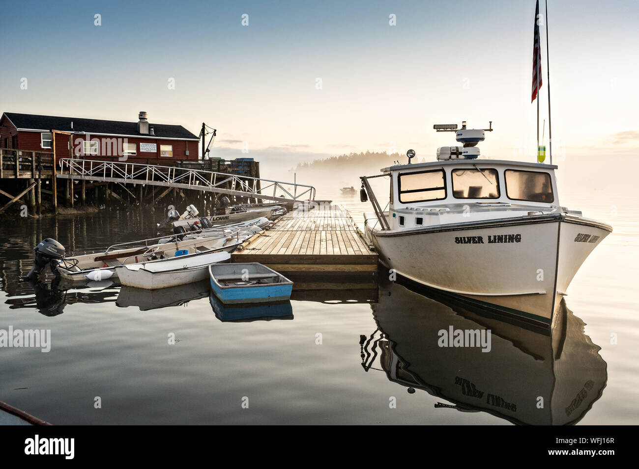 Lobstermen prepare to head out on the water during a foggy morning