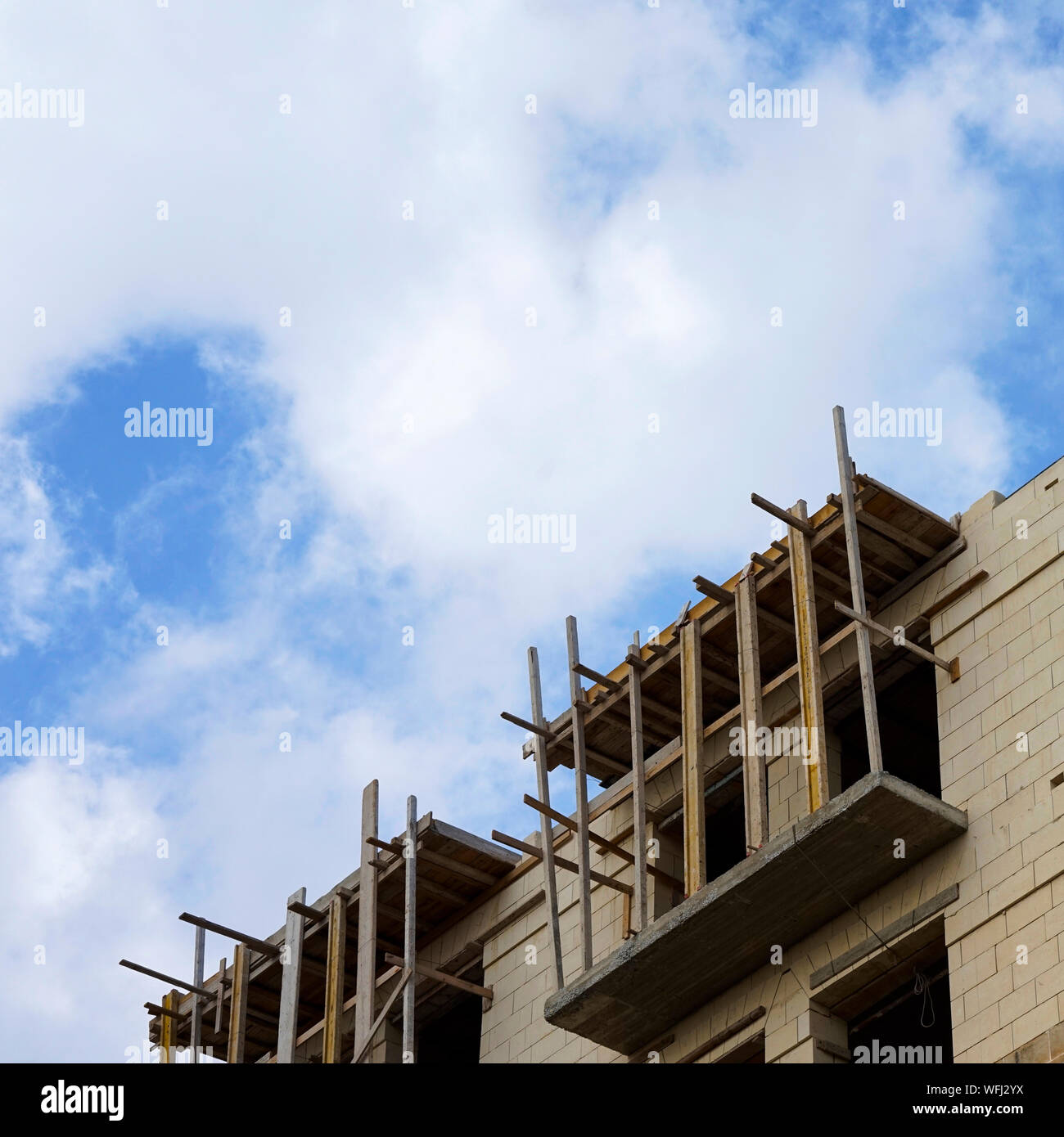 Low Angle View Of Incomplete Building At Construction Site Against Cloudy Sky Stock Photo