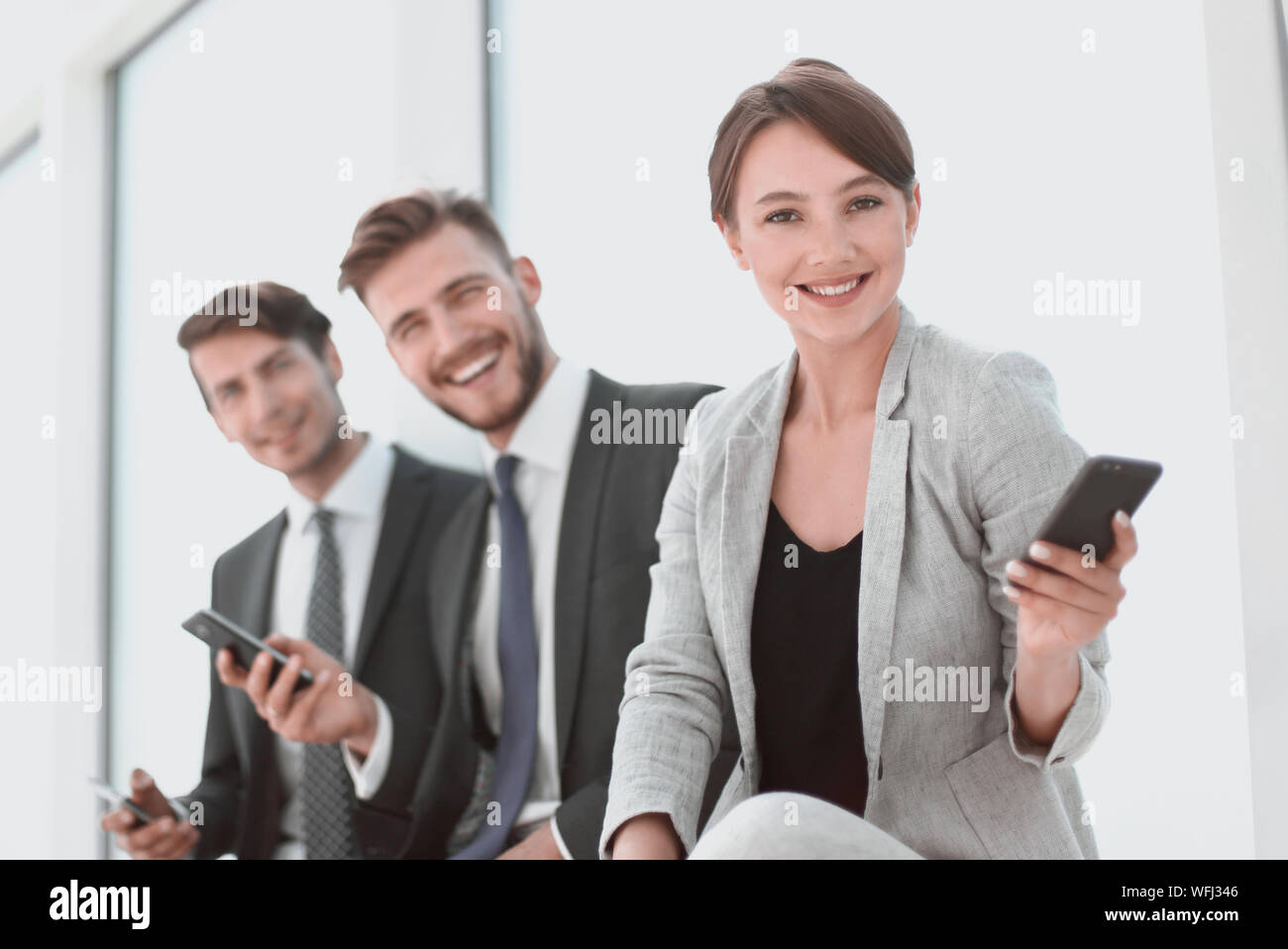 successful business team sitting in the office lobby Stock Photo - Alamy