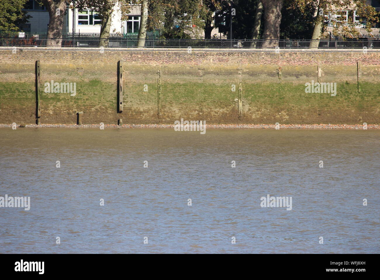 A photograph of the banking of the river Thames across the river from Greenwich. Stock Photo