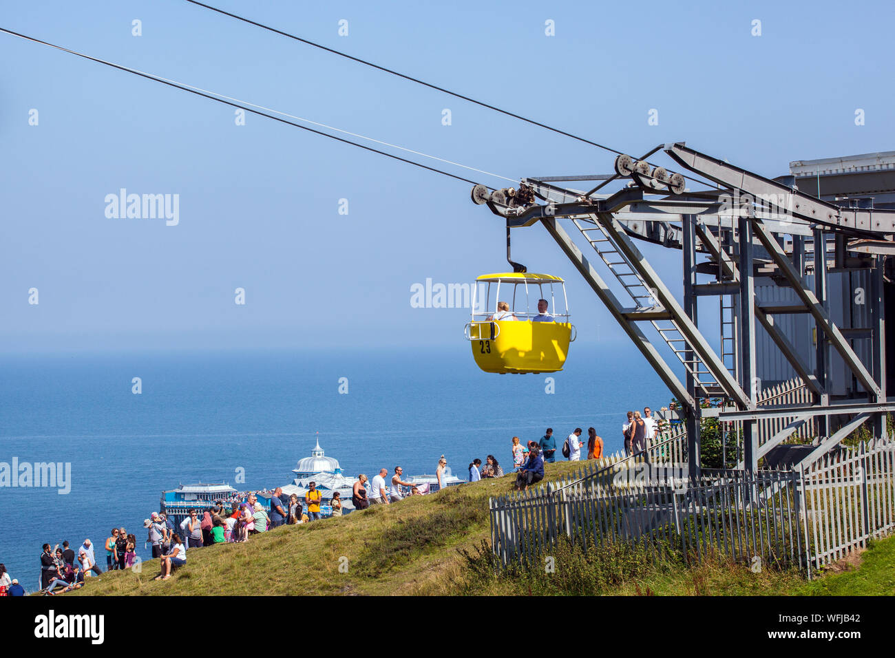 People tourists holidaymakers queuing for the cable car coming out of the cable car station at the seaside holiday resort of Llandudno North Wales Stock Photo