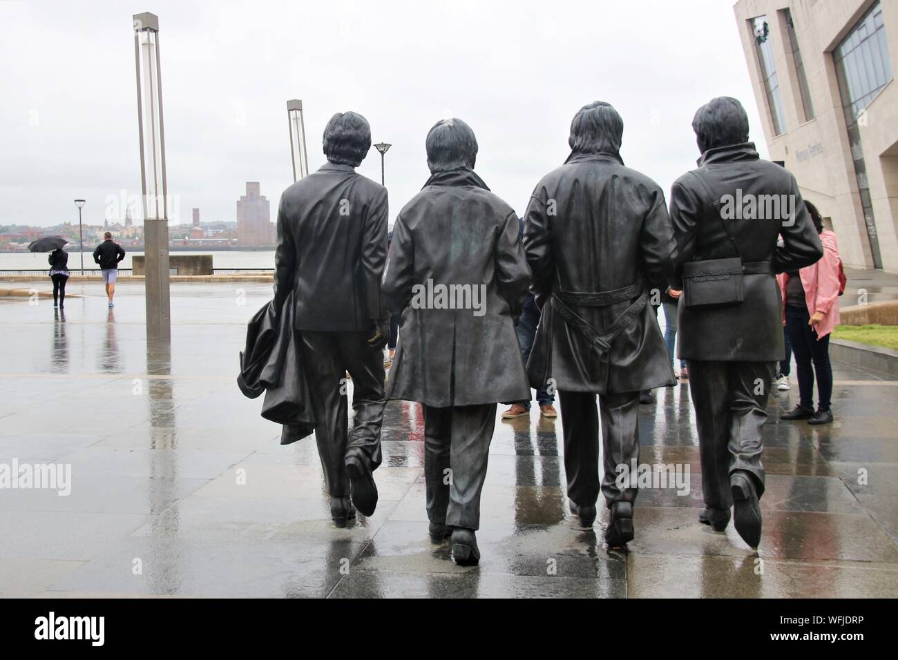 Sculpture of the Beatles on Pier Head, Merseyside, Liverpool, in rainy weather. Installed in 2015. Artist: Andy Edwards. Europe. Stock Photo