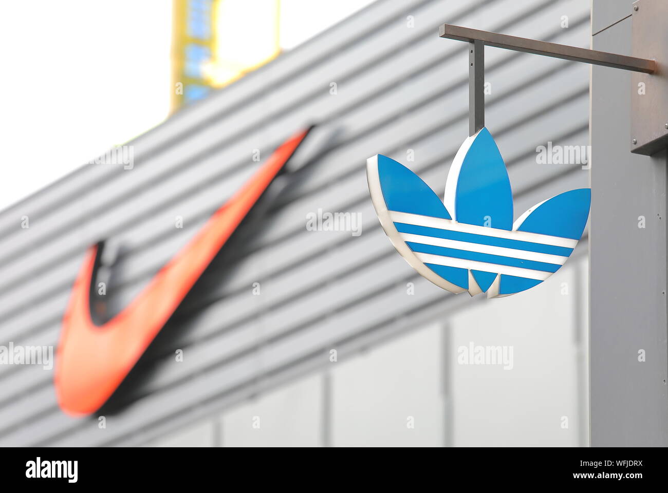 Adidas company logo and Nike company logo in background Stock Photo - Alamy
