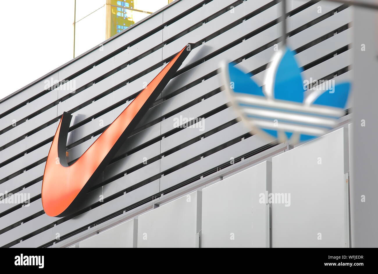 Nike company logo and Adidas company logo in foreground Stock Photo - Alamy