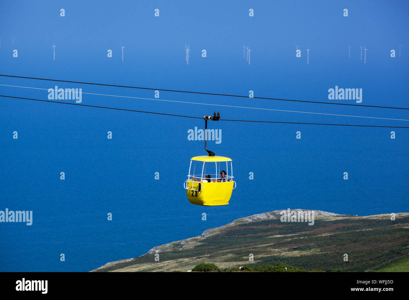 The colourful Llandudno Cable Car as it passes over the Great Orme