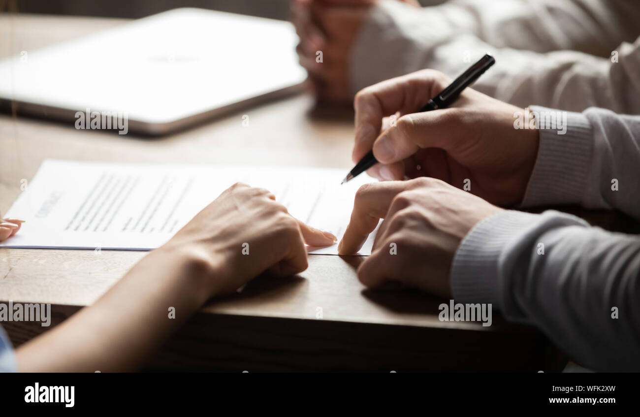 Solicitor pointing at contract showing client where to write signature Stock Photo