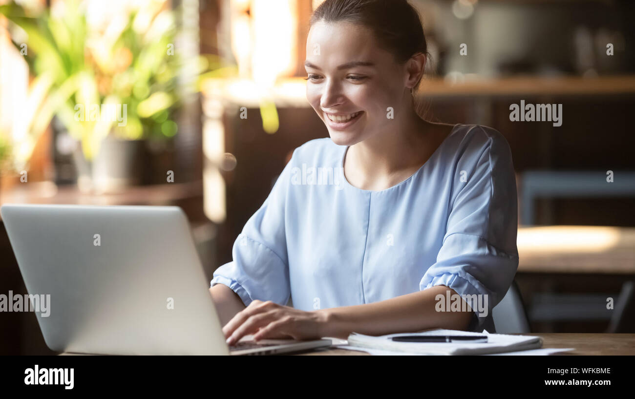 Happy young business woman student using computer in office cafe Stock ...
