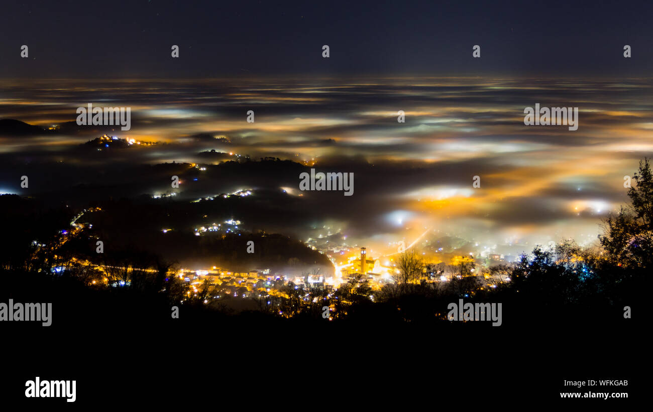 Plain illuminated partially covered by fog, soft lights.  Mount Grappa, Italian landscape Stock Photo
