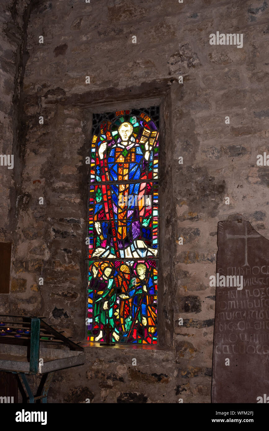 Stained glass and ogham stone, old priory, Caldey number 3820 Stock Photo