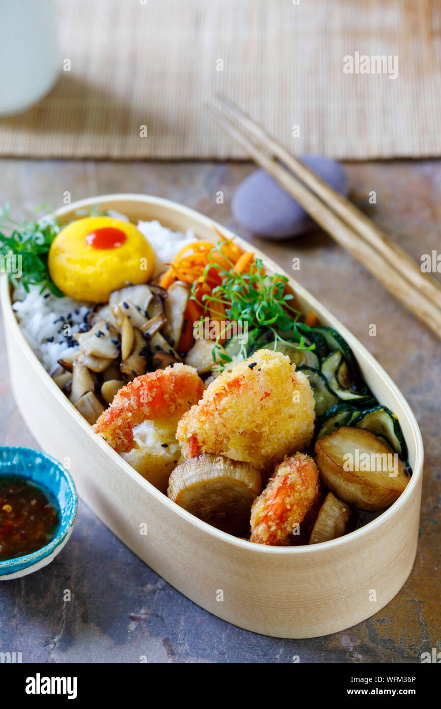 Japanese bento box with tempura prawns, rice and vegetables Stock Photo