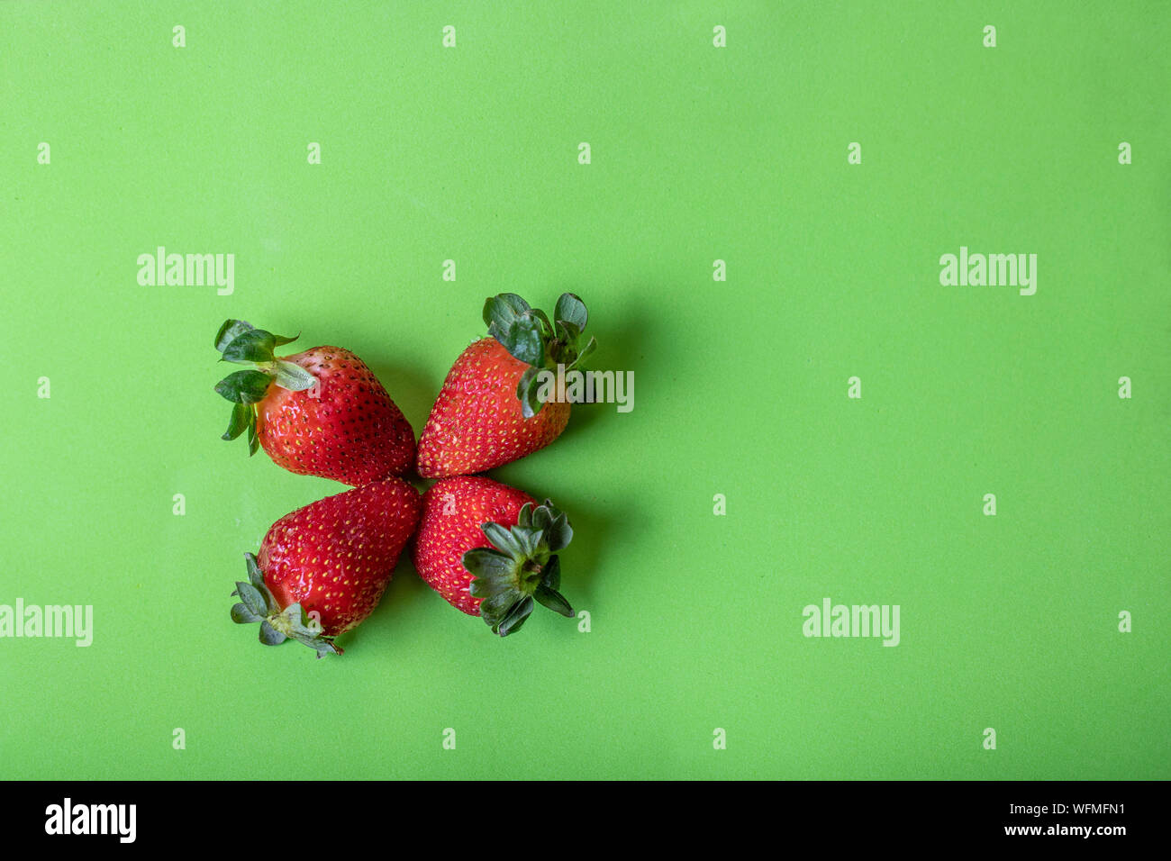 Strawberries are beautiful and tasty, a simple presentation with a vibrant background. Stock Photo