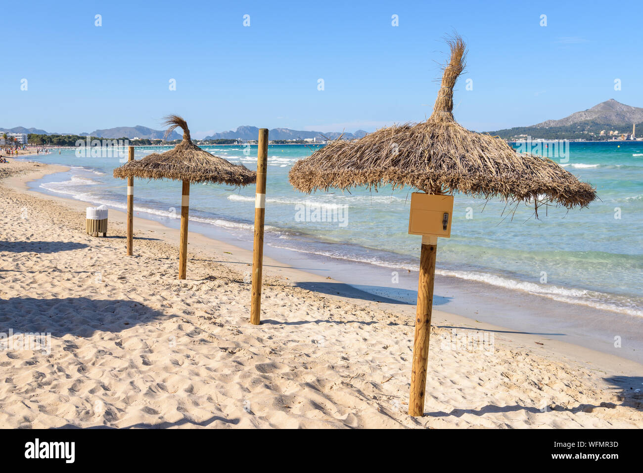 Umbrellas at the Playa de Muro beach in Mallorca, Spain Stock Photo