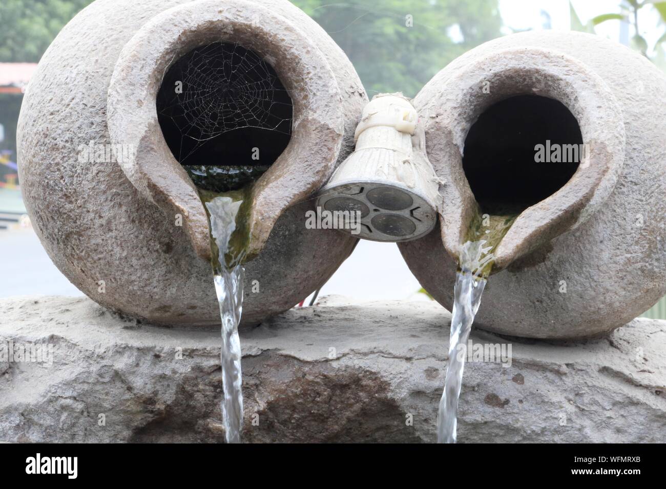 Water Pouring From Clay Made Rusty Pot Stock Photo