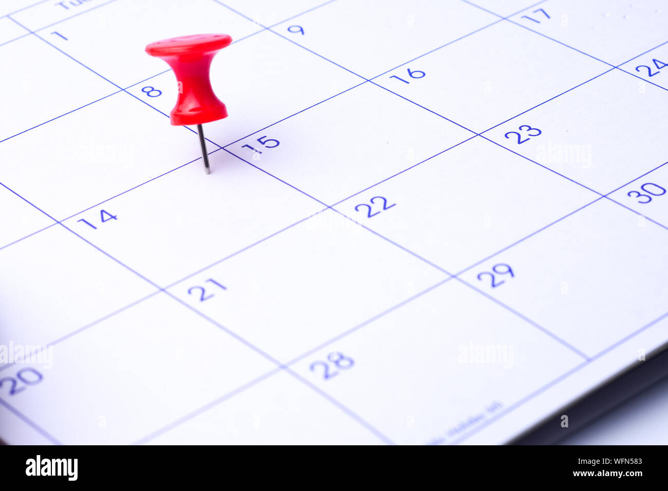 Close-up High Angle View Of Thumbtack On Calendar Date Stock Photo