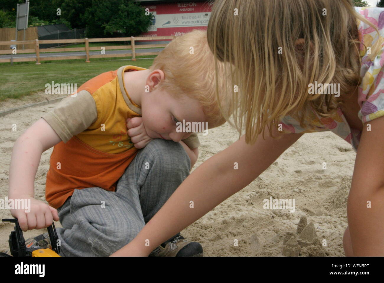 Siblings Playing At Playground Stock Photo