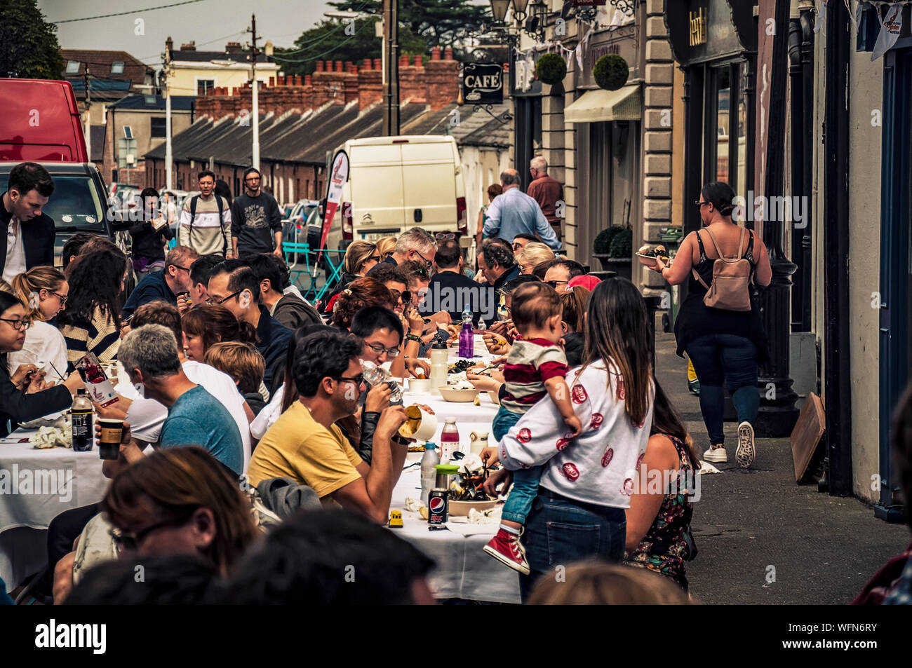 Outside tables of the Irish pub full of visitors. Dalkey, Dublin