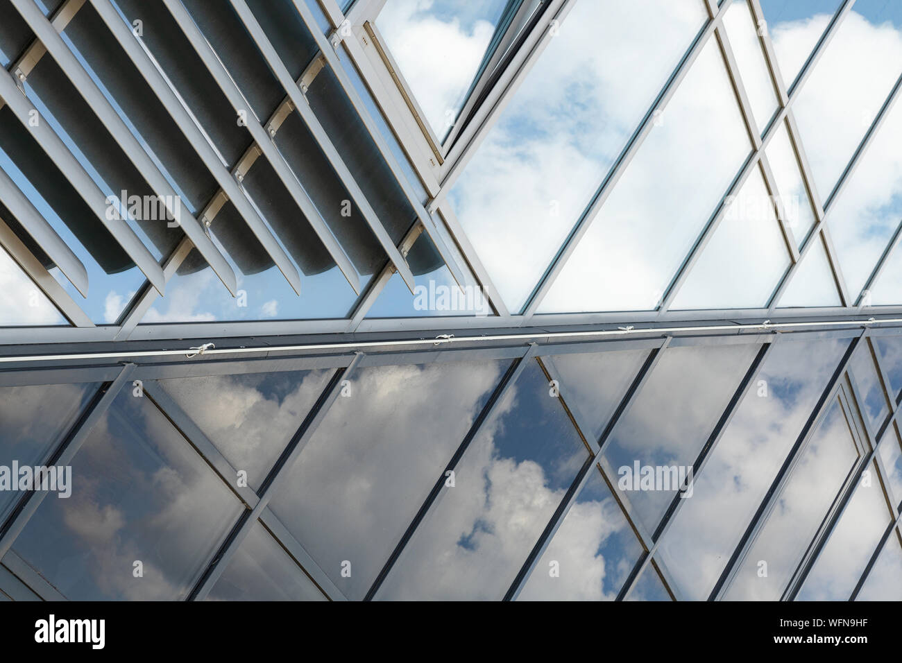 shiny glass wall with darkening glass and sheer glass joint with sky