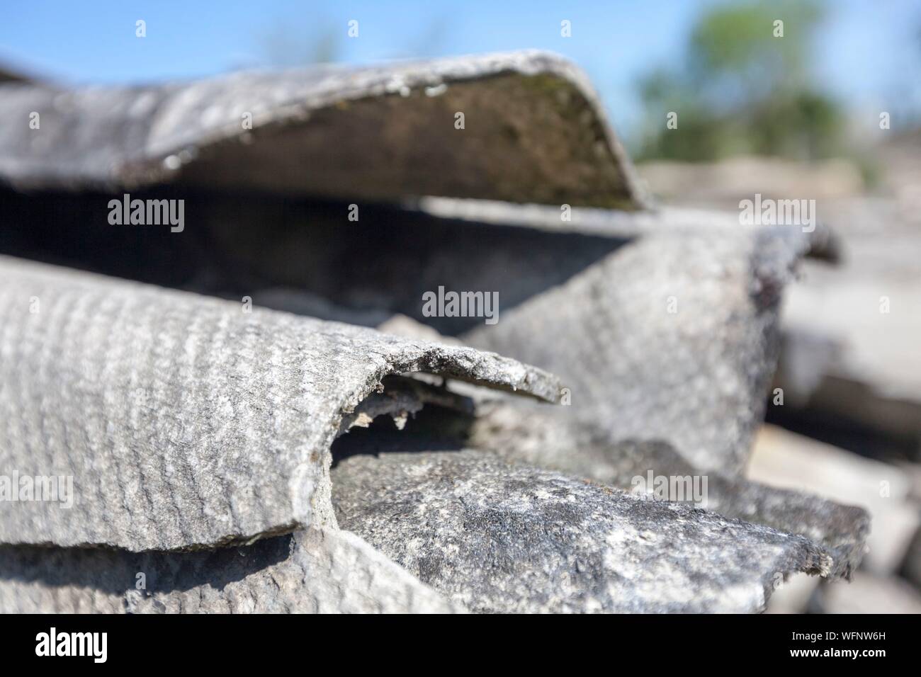 France, Vienne, Chatellerault, demolition site with an asbestos issue, close up view of the broken and fibrous slice of corrugated asbestos cement sheets Stock Photo